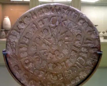 img_0261 The Phaestos disk is a 15cm-diameter disk of clay with hieroglyphs incised on both sides, spiralling from the rim to the center of the disk. The script has not...