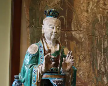 IMG_6379 Stoneware figure of a Daoist deity, Ming dynasty, 16th century. The hat, throne and beard distinguish him from Buddhist deities.